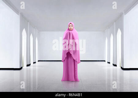 Young asian woman wearing veil and praying Stock Photo