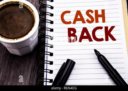 Writing text showing Cash Back Cashback. Business concept for Money Assurance written on notebook book note paper on the wooden wood background. With coffee and black marker. Stock Photo