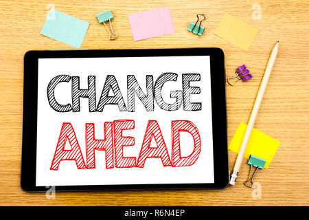 Writing text showing Change Ahead Red Word. Business concept for Future Changes Written on tablet laptop, wooden background with sticky note and pen Stock Photo