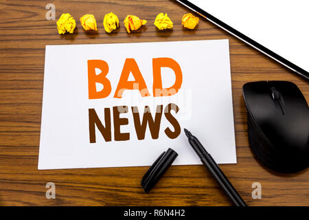 Conceptual hand writing text showing Bad News. Business concept for Failure Media Newspaper written on sticky note paper on the wooden background with marker mouse and tablet office view. Stock Photo