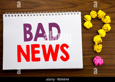 Conceptual hand writing caption inspiration showing Bad News. Business concept for Failure Media Newspaper written on notepad note paper on the wooden background with question mark. Stock Photo