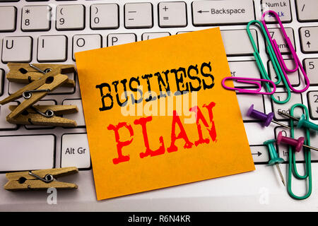 Writing text showing Business Plan. Business concept for Mission or Vision written on sticky note paper on the white keyboard background. Stock Photo