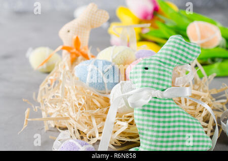 Easter composition with bunnies, eggs and tulips. Stock Photo