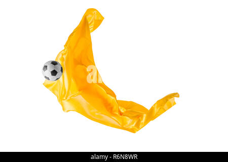 Soccer ball and Smooth elegant transparent yellow cloth isolated or separated on white studio background. Stock Photo