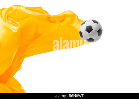 Soccer ball and Smooth elegant transparent yellow cloth isolated or separated on white studio background. Stock Photo