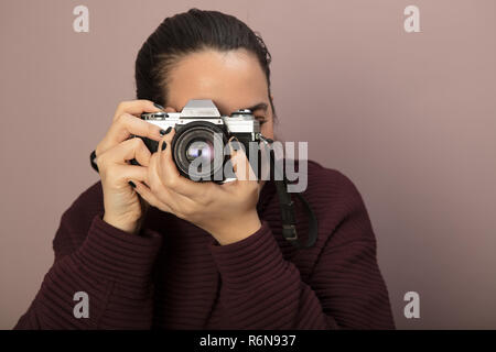 Photographer taking photos with a old SLR camera Stock Photo