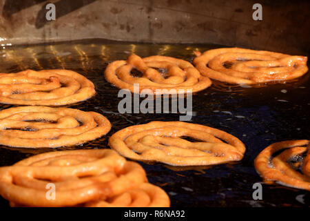 Jalebis being deep fried in oil, at a food stall at Kalagram, during the 10th National Crafts Mela. Stock Photo