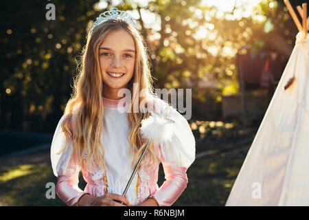 Beautiful little girl wearing a fairy costume kissing her 