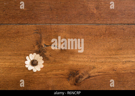 a wooden flower on the wooden floor Stock Photo