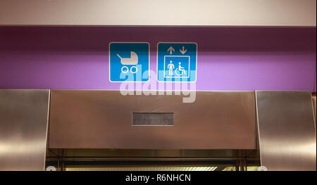 access for stroller and disabled sign over a lift door Stock Photo