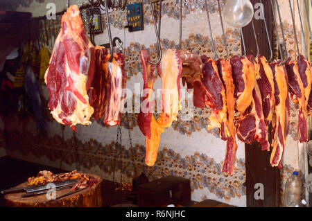 Fresh raw red meat at butcher shop for display. Burrabazar ( Bara Bazaar) is a marketplace, largest wholesale butchery markets store in India. Stock Photo