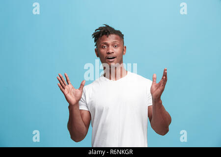 Handsome afro-american man looking suprised isolated on blue Stock Photo