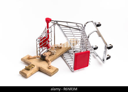 Shopping cart overturned with crucifix on the ground Stock Photo