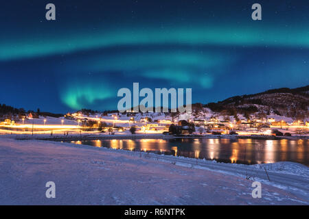 Beautiful winter night landscape with northern lights, Aurora borealis, Gausvik, Lofoten Islands, Norway Stock Photo