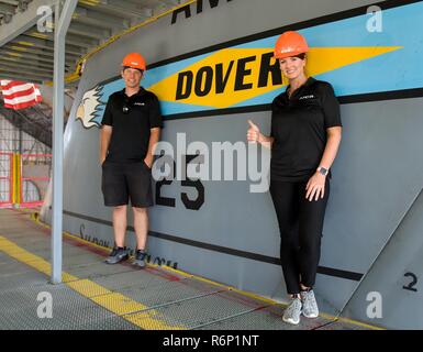 Jennifer Jo Cobb, NASCAR Camping World Truck Series driver for truck #10, right and Allen Chambers, Jennifer Jo Cobb Racing team member, left, stand by the C-5M Super Galaxy T-tail flash, May 31, 2017, at the C-5 Isochronal Inspection Dock on Dover Air Force Base, Del. Cobb and Chambers climbed up the T-tail to get a birds-eye view of a Super Galaxy undergoing maintenance. She and four members of the JJCR team toured the Air Traffic Control tower and the Isochronal Inspection Dock prior to race weekend at Dover International Speedway, Dover, Del., June 2-4, 2017. Stock Photo