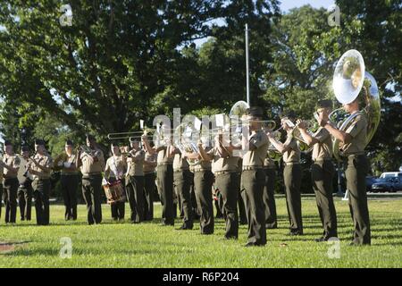 U.S. Marine Corps band with 2d Marine Division (2d MARDIV) plays during the morning colors ceremony on Camp Lejeune, N.C., May 26, 2017. The Commanders and service members of 2d MARDIV observed the raising of the colors and playing of the service songs to honor military traditions. Stock Photo