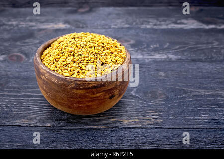 Fenugreek in clay bowl on board Stock Photo