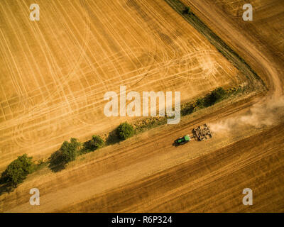 Aerial view of a country road amid fields with a car on it Stock Photo
