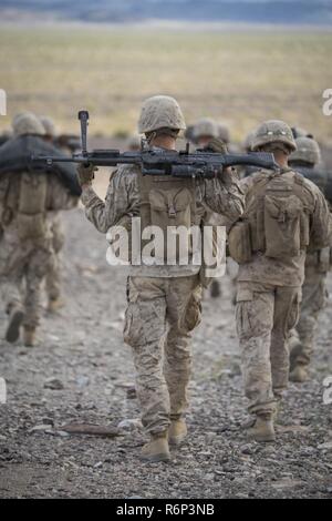 MARINE CORPS AIR GROUND COMBAT CENTER TWENTYNINE PALMS, California – Pfc. Brenan Prince, a machine gunner with Alpha Company, 1st Battalion, 8th Marine Regiment, carries a M240 Bravo Medium Machine Gun prior to a training exercise aboard the Marine Corps Air Ground Combat Center Twentynine Palms, California, May 7, 2017. The Marines conducted a company level assault reinforced by machine guns, vehicles, mortars and snipers as part of Integrated Training Exericse 3-17. Integrated Training Exercise is a training evolution conducted five times a year to enhance the lethality and co-operability be Stock Photo