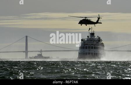 Coast Guard crewmembers from Maritime Safety and Security Team 91109, based in San Diego, fast-rope from a California Air National Guard 129th Rescue Wing HH-60G Pave Hawk helicopter during an interagency training exercise on the San Francisco Bay, April 25, 2017. Members from Station San Francisco, Coast Guard Cutter Hawksbill and MSST 91105, based in San Francisco, supported the interagency training exercise. U.S. Coast Guard Stock Photo