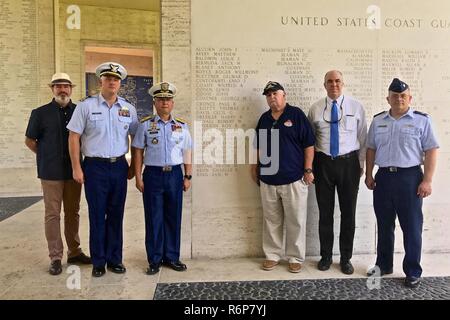 Officer-in-Charge Commodore Joel Garcia, Philippine coast guard, Lt. Cmdr, Jeremy Obenchain ,U.S. Coast Guard, maritime advisor Defense Threat Reduction Agency and U.S. Embassy, and Chief Petty Officer John O’Neil, U.S. Coast Guard Combat Veterans Association,  and other guest stand for a photo at the Military American Cemetery, May 9, 2017. The ceremony was culminated with the reveal of  Lt. Crotty’s name now etched on the U.S. Coast Guard wall in the cemetery. Stock Photo