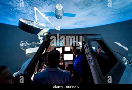 NASA Astronaut Col. Tyler 'Nick' Hague talks with Canadian Space Agency astronaut David Saint Jacques, before rendezvous and robotic arm retrieval training in the Systems Engineering Simulator, called 'The Dome', at Johnson Space Flight Center in Houston, Tex., Apr. 26, 2017. Stock Photo