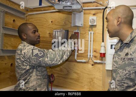 At left, Master Sgt. Brian Lee, superintendent, explains a system 