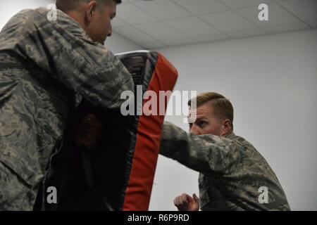 Staff Sgt. William Lamb, 741st Missile Security Forces Squadron tactical response force nuclear advance designated marksman program manager, right, practices combatives with Airman 1st Class Cristian Hernandez Mendoza, 341st MSFS response force leader, May 25, 2017, at Malmstrom Air Force Base, Mont. The Airmen are slated to leave for Joint Base McGuire-Dix-Lakehurst, N.J., in June for Phoenix Raven training. Stock Photo