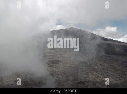 Ascending clouds at the summit of the Piton de la Fournaise Stock Photo
