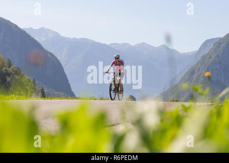 Active sporty woman riding mountain bike in nature. Stock Photo