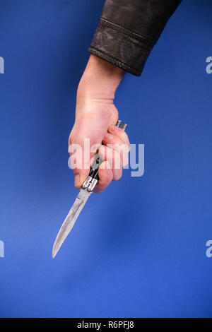 Switchblade knife in hand close up male robber holding black knife ...