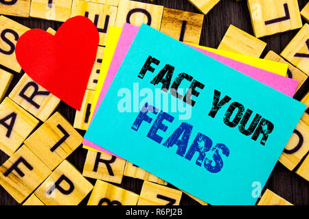 Handwritten text showing Face Your Fears. Conceptual photo Challenge Fear Fourage Confidence Brave Bravery written on colorful sticky note on the letter background Love Heart for Loving Stock Photo