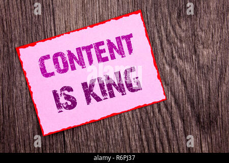 Handwriting Announcement text showing Content Is King. Conceptual photo Online Marketing Information Management With cms Or Seo Data written on Pink Sticky Note Paper on the wooden background. Stock Photo