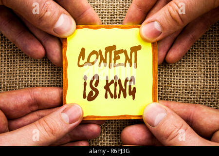 Conceptual hand writing showing Content Is King. Business photo showcasing Online Marketing Information Management With cms Or Seo Data written on Sticky Note Paper Holding Hand with Finger. Stock Photo