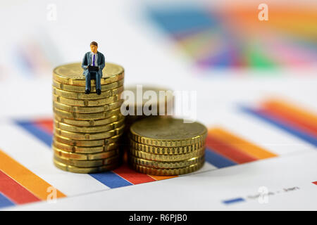 business growth concept - businessman sitting on coin stack Stock Photo