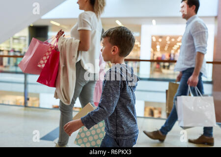 Family and two kids go shopping around the mall Stock Photo