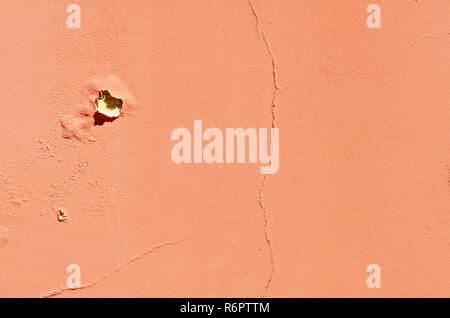 Texture of cracked wall. Old terracotta painted background. Banner with cracks, scrapes, peeling, holes. Stock Photo