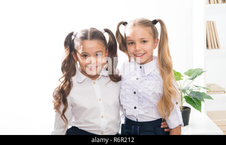 Schoolgirls with cute pony tails hairstyle. Best friends excellent pupils. Perfect schoolgirls with tidy fancy hair. School hairstyles ultimate top list. Shine bright. School fashion and style. Stock Photo
