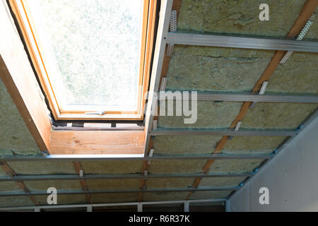 house attic under construction mansard wall insulation with rock wool Stock Photo