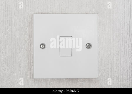 British light switch, in white or ivory colour,  in on position. Stock Photo