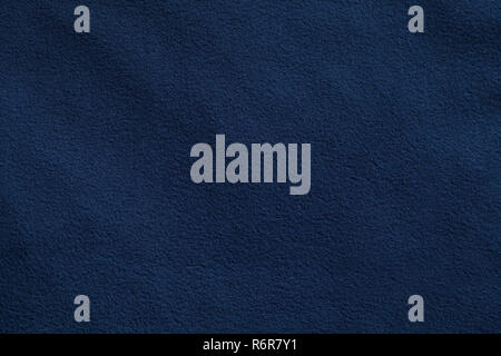 Texture of dark blue fleece, soft napped insulating fabric made from polyester Stock Photo