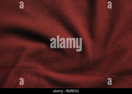 Texture of red fleece, soft napped insulating fabric made from polyester, wavy pattern Stock Photo