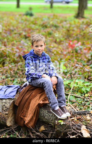 Camping is very special to me. Small boy enjoy camping trip. Small traveler in camping area. Little boy relax on tree in woods. Im really an outdoorsy boy Stock Photo