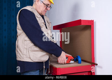 plumber at work on his workbench to fit pipes Stock Photo
