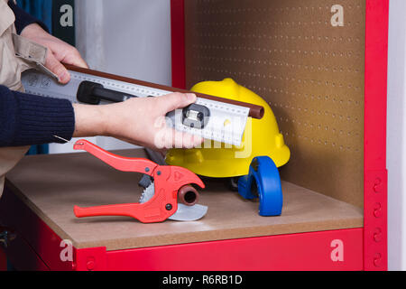 plumber at work on his workbench to fit pipes Stock Photo