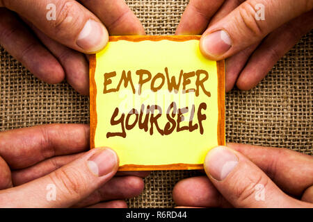 Conceptual hand writing showing Empower Yourself. Business photo showcasing Positive Motivation Advice For Personal Development written on Sticky Note Paper Holding Hand with Finger. Stock Photo