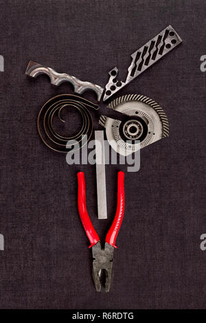 Screws, cogwheels and mechanical components on concrete. Stock Photo