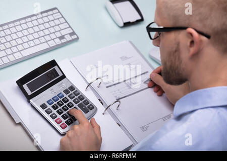 Businessman Calculating Invoice Stock Photo