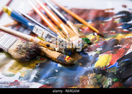 Close-up Of Various Messy Paintbrushes