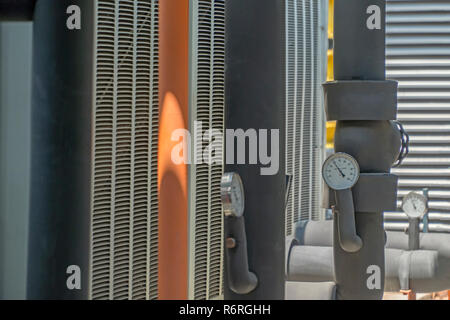 Black pipe are insulated with pressure gauge. Stock Photo